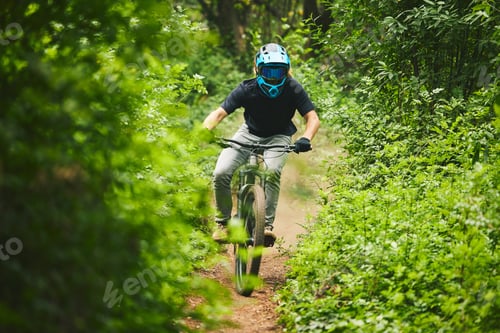 Preview: Man, mountain bike and extreme sports in forest for adventure, speed and power in park. Athlete, fr