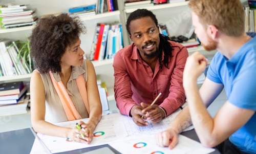 Preview: Team of happy successful architects working on construction plans in office