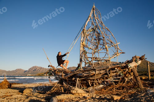 Preview: Young woman on decorative wooden ship near water on shore