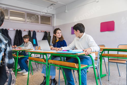 Preview: Students collaborating on laptop in modern classroom
