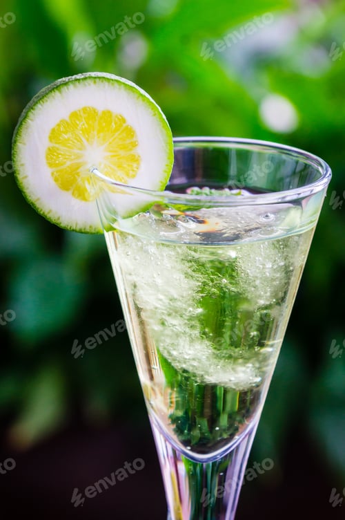 Preview: Vertical shot of fresh cocktail with a slice of lime
