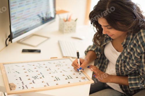 Preview: Woman wrinting on calendar