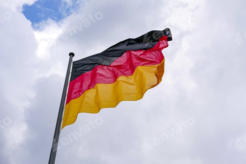Preview: Low angle shot of a waving flag of Germany against cloudy sky