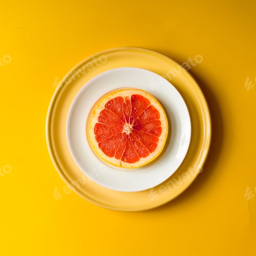 Preview: Red grapefruit slice on plate.