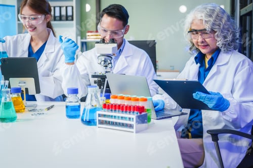 Preview: Two Asian men and women sit at a table in a laboratory, conducting research on liquids. They use