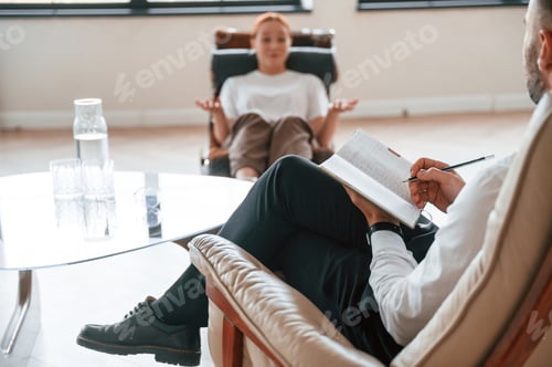 Preview: Woman is sitting in chair at an appointment with a psychologist