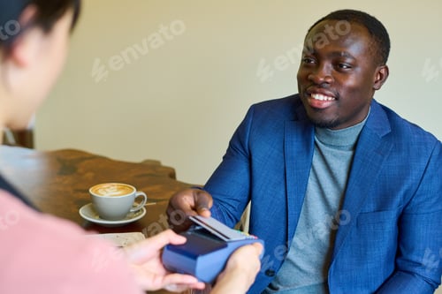 Preview: Man paying for his order in cafe