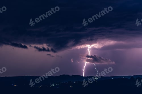 Preview: Night landscape on a background of thunderstorms. Rural silhouette and clouds with lightning flashes