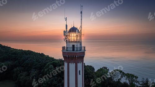Preview: Light beam from lighthouse during sunset at Baltic Sea.