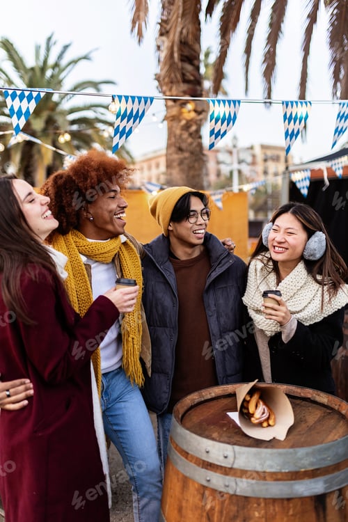 Preview: Young group of diverse people in winter clothes having fun on christmas vacation