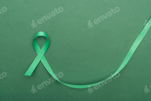 Preview: top view of green and colorful ribbon on green background with copy space
