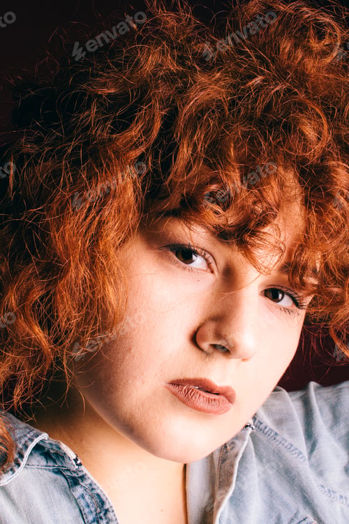 Preview: Portrait Of A Beautiful Girl With Curly Red Hair