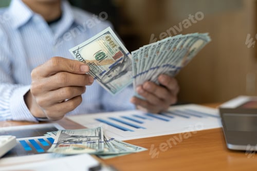 Preview: Wealthy man holding banknotes counting money. Accounting and income-expenses financial planning.