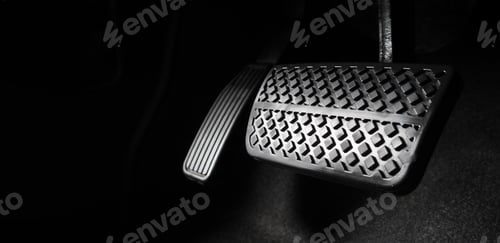 Preview: Foot pressing foot pedal of a car to drive. Accelerator and brake pedal in a car.