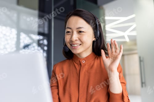 Preview: Happy Asian woman working inside office, businesswoman with video call headset talking and advising