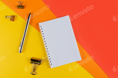 Preview: Yellow office desk table with blank notebook and other office supplies