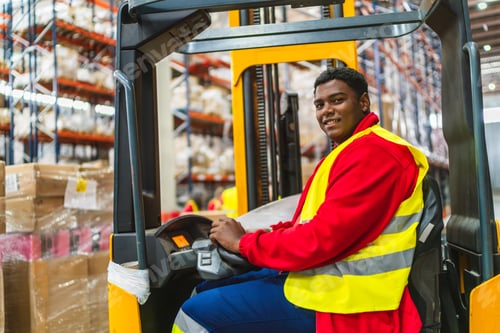 Preview: Warehouse worker driving forklift in logistics center
