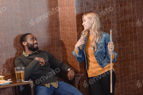 Preview: two young friends at pub with beer and food