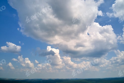 Preview: Bright landscape of white puffy cumulus clouds on blue clear sky