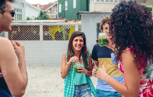 Preview: Happy people with beverages laughing in summer party