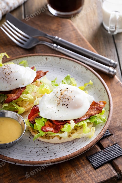 Preview: Eggs Benedict with bacon and lettuce on english muffins