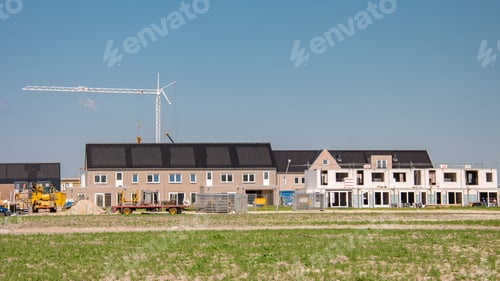 Preview: Newly build houses with solar panels attached on the roof against a sunny sky
