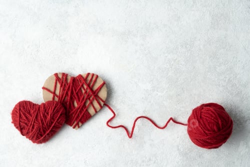Preview: Two hearts made of red woolen yarn, Valentine's day concept.
