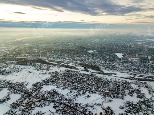 Preview: Top view of city suburbs or small town nice houses on winter morning on cloudy sky