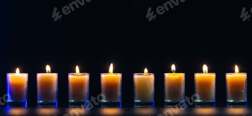Preview: Burning candle on black background with backlight. Memorial Day.