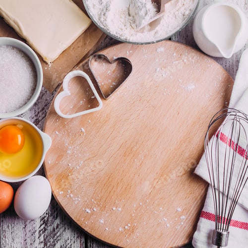 Preview: Ingredients for baking Valentines day cake - eggs, flour, milk, butter, sugar on wooden board.