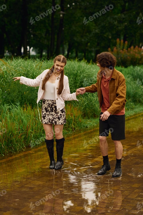 Preview: Loving couple enjoys a playful stroll through a rainy park, sharing joyful moments and laughter