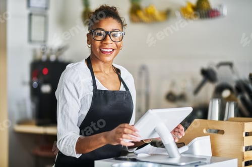 Preview: friendly shop assistant ready to take customer orders at register in restaurant