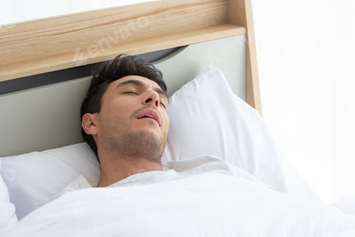 Preview: Man was sleep and snore in the white bedroom of the apartment