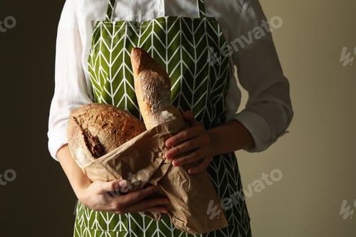Preview: Woman in apron hold fresh baked bread