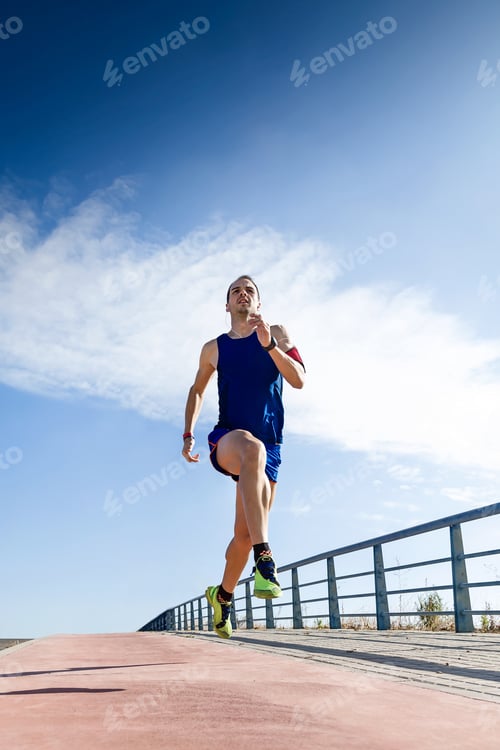 Preview: Handsome young man running in the park.