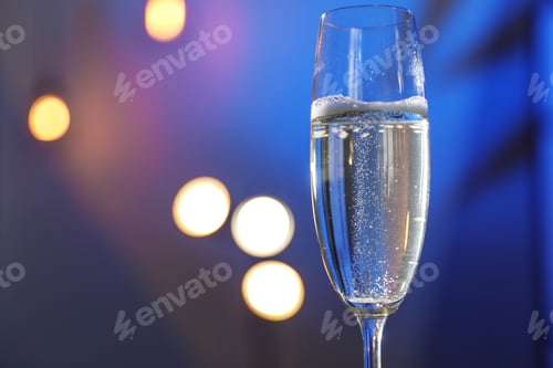 Preview: Glass of champagne on color background, closeup. Space for text