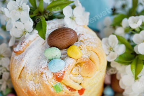 Preview: Traditional cupcake Easter cake kraffin with raisins on blue background.