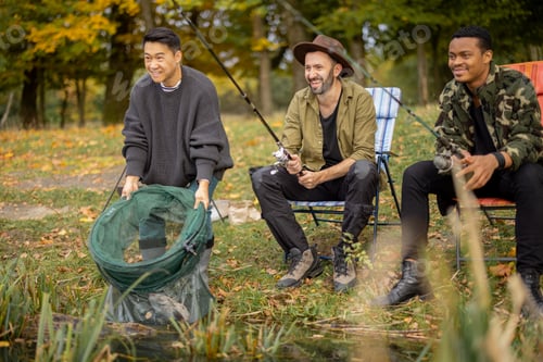 Preview: Pleased male friends resting and fishing in nature