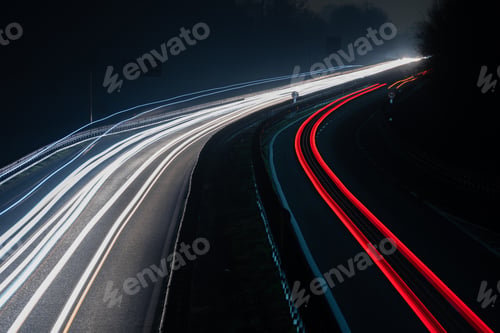 Preview: Abstract image of night traffic lights on the road. Car light trails at night in curve asphalt road