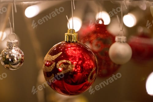Preview: Brightly Lit Christmas Ornaments Hanging in Festive Display