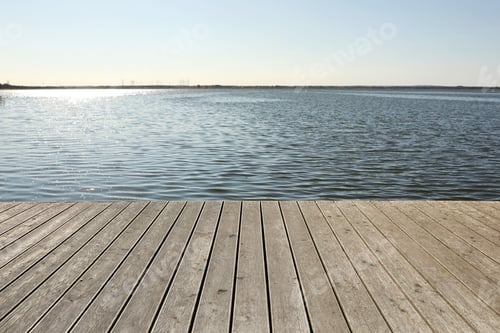 Preview: Beautiful view of wooden terrace near river on sunny day