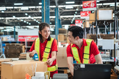Preview: Warehouse worker checking details stock product and scanning a barcode on box package.