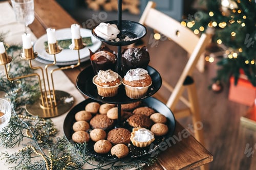Preview: Festive Christmas table with sweet cookies and cakes in the kitchen with decorations.