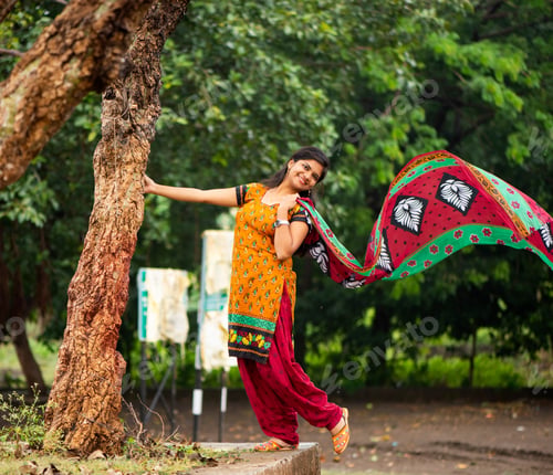 Preview: Young girl near tree trunk and she enjoying fresh air outdoors