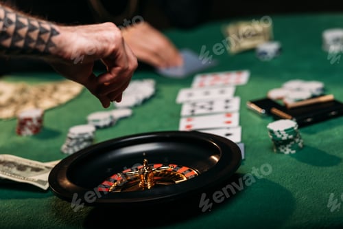 Preview: cropped image of woman and tattooed man playing roulette table in casino