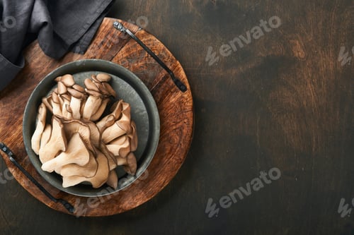 Preview: Fresh oyster mushrooms. Iron old bowl of delicious organic oyster mushrooms on old wooden background