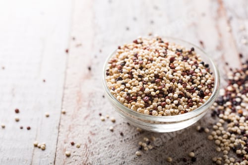 Quinoa Seeds in a Glass Bowl on Wood