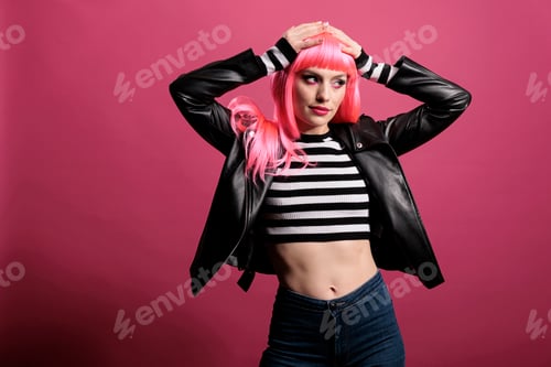 Preview: Young stylish woman with pink hair wearing punk leather jacket