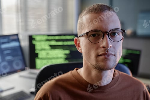 Preview: Portrait of Adult Male IT Programmer with Glasses and Septum Posing in Office