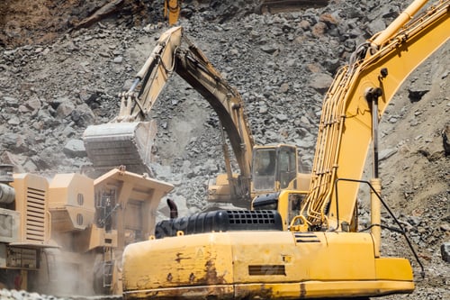 Preview: details of industrial excavator working on construction site and loading rock crusher